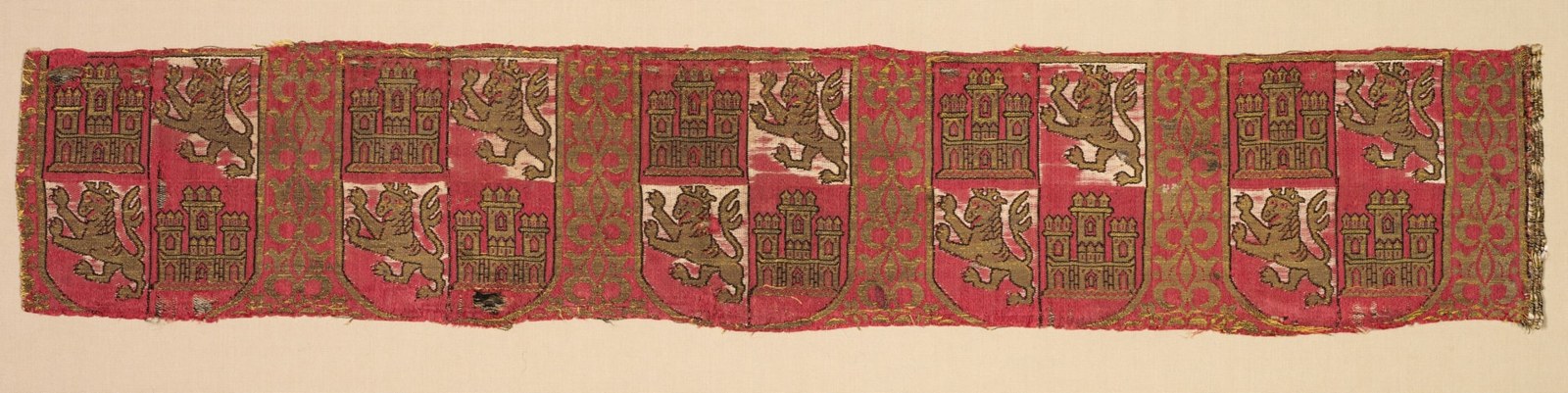 A narrow strip repeats small quartered shields between ornamental bands. Castles and upright animals alternate within each armorial field.